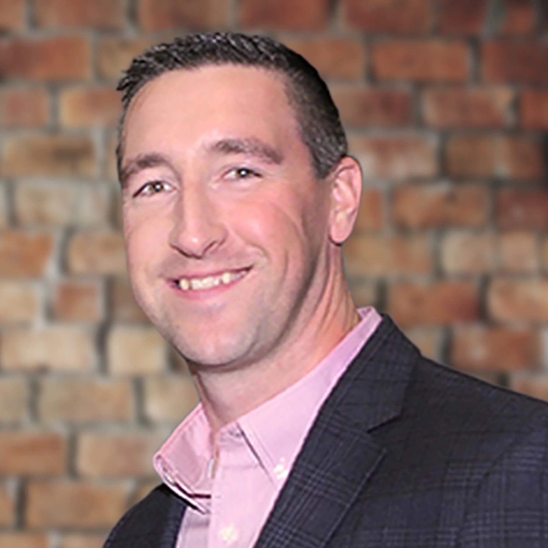 photo of david druzynski in a pink shirt and suit jacket