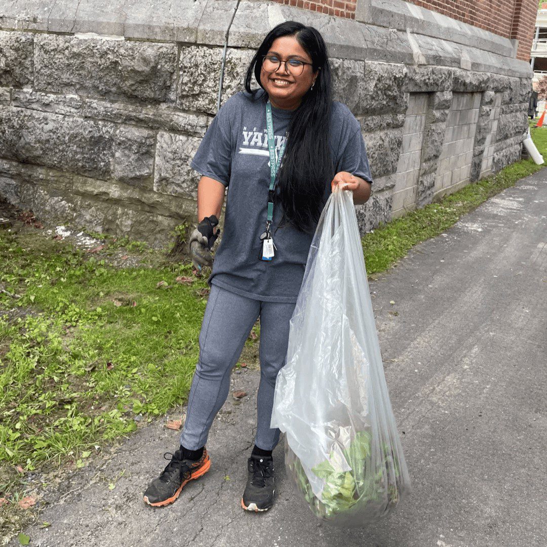 woman with bag cleaning up park