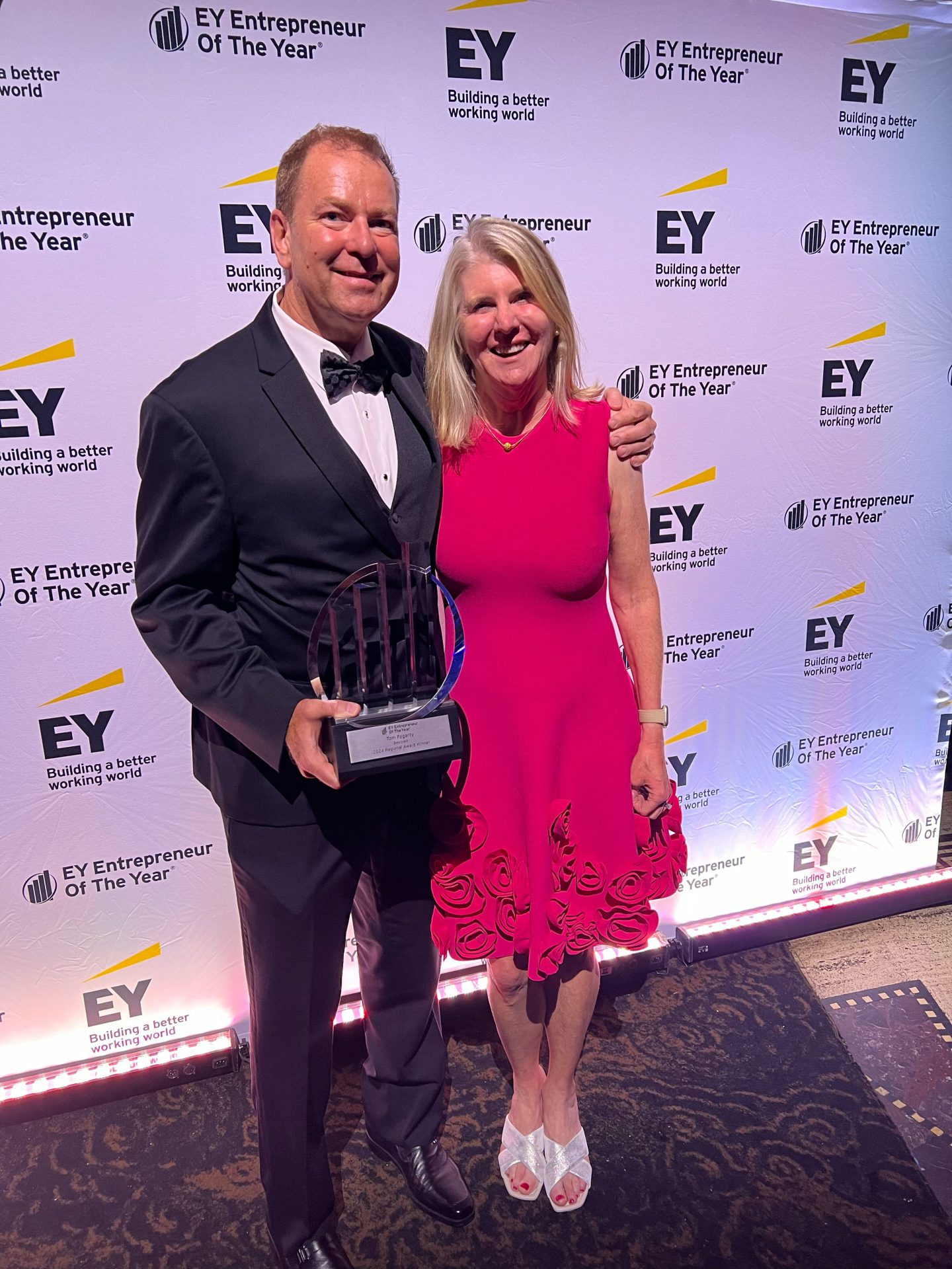 Tom Fogarty and his wife posing for photo with award