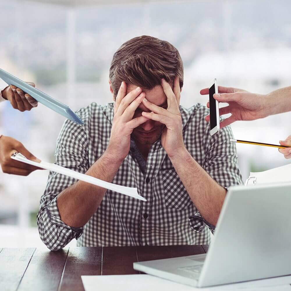 Man sitting at a table distressed over toll