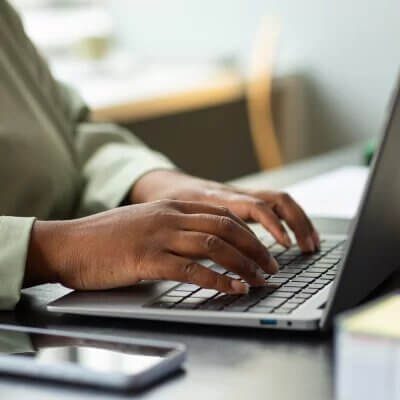 Image of a laptop computer with hands