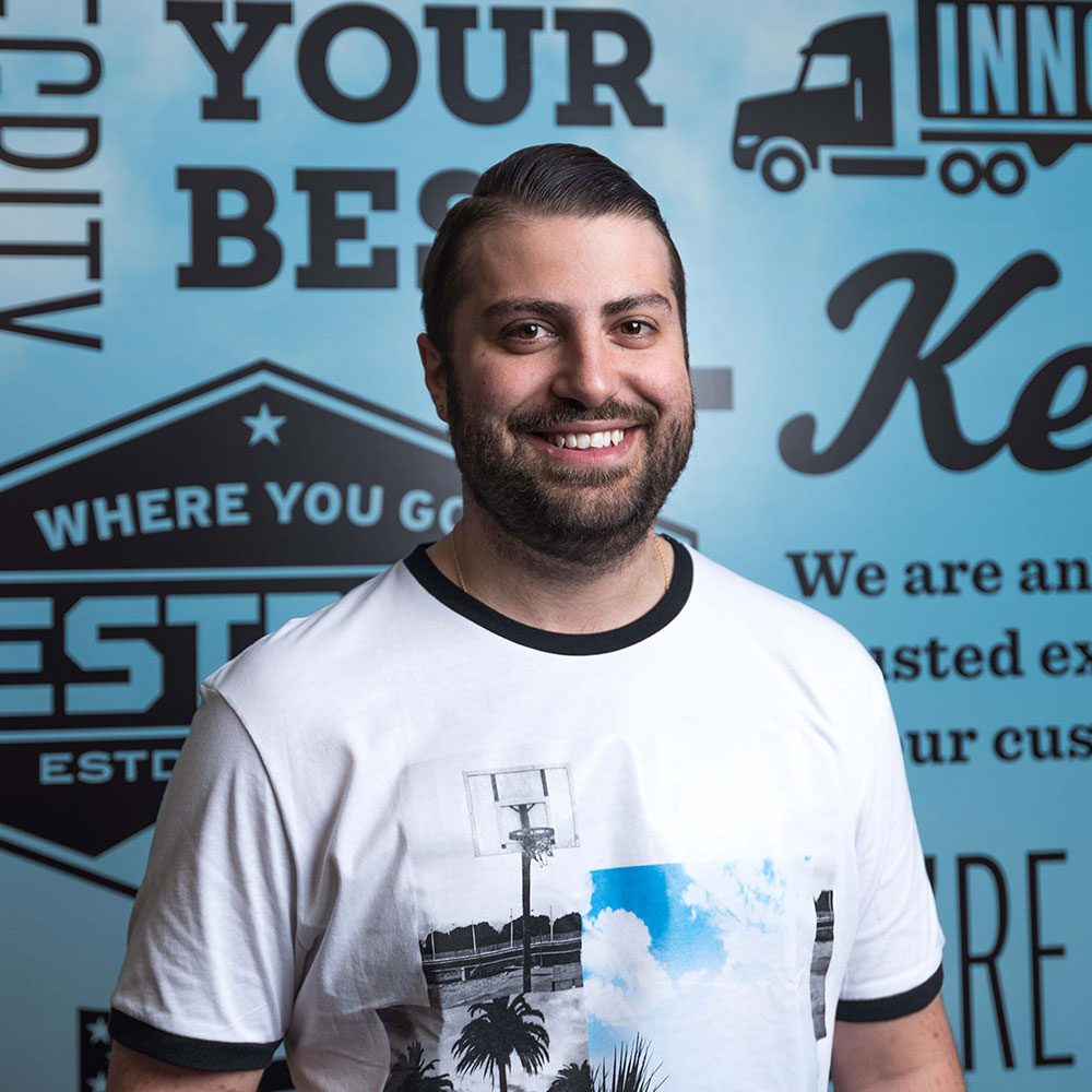Man in standing in front of Bestpass wall
