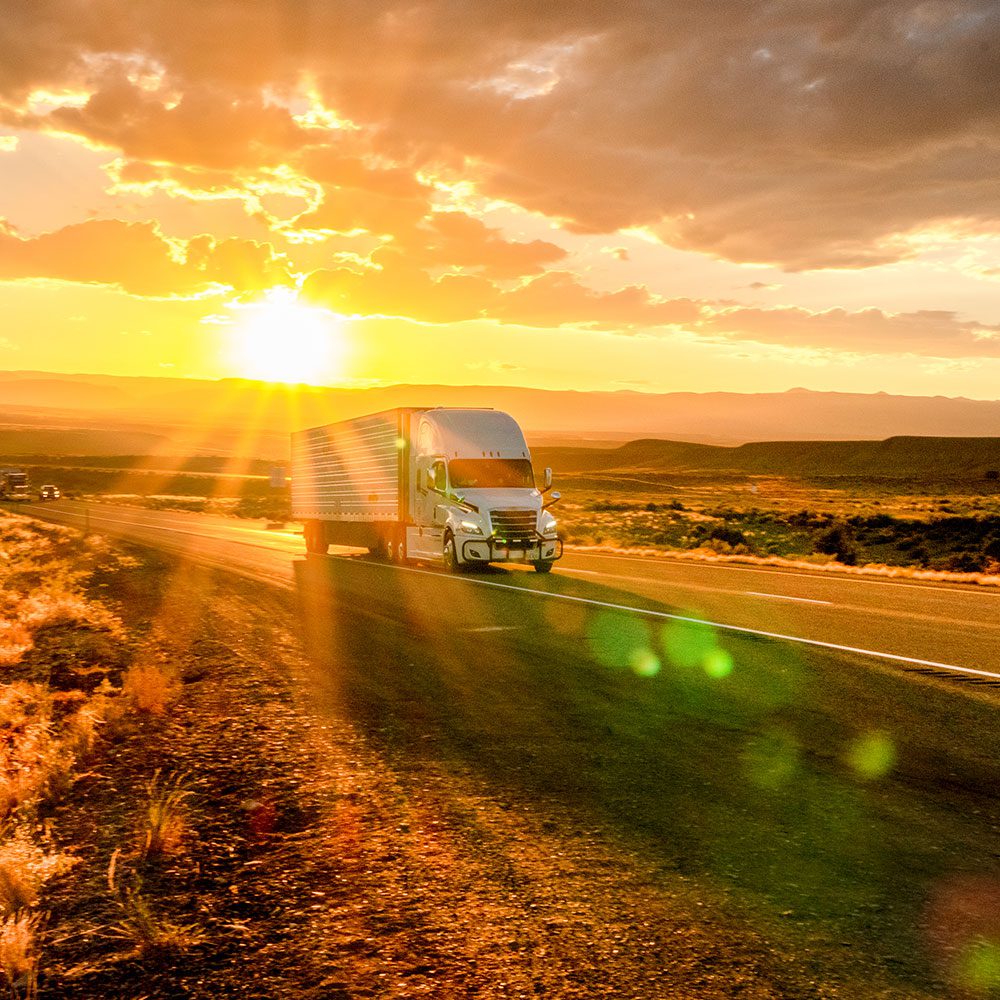 sunlight backed truck on open road